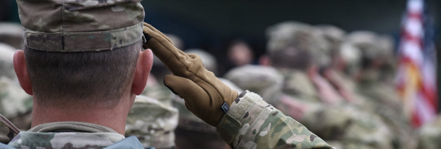 Military personnel saluting during a ceremonial event, showcasing dedication and honor